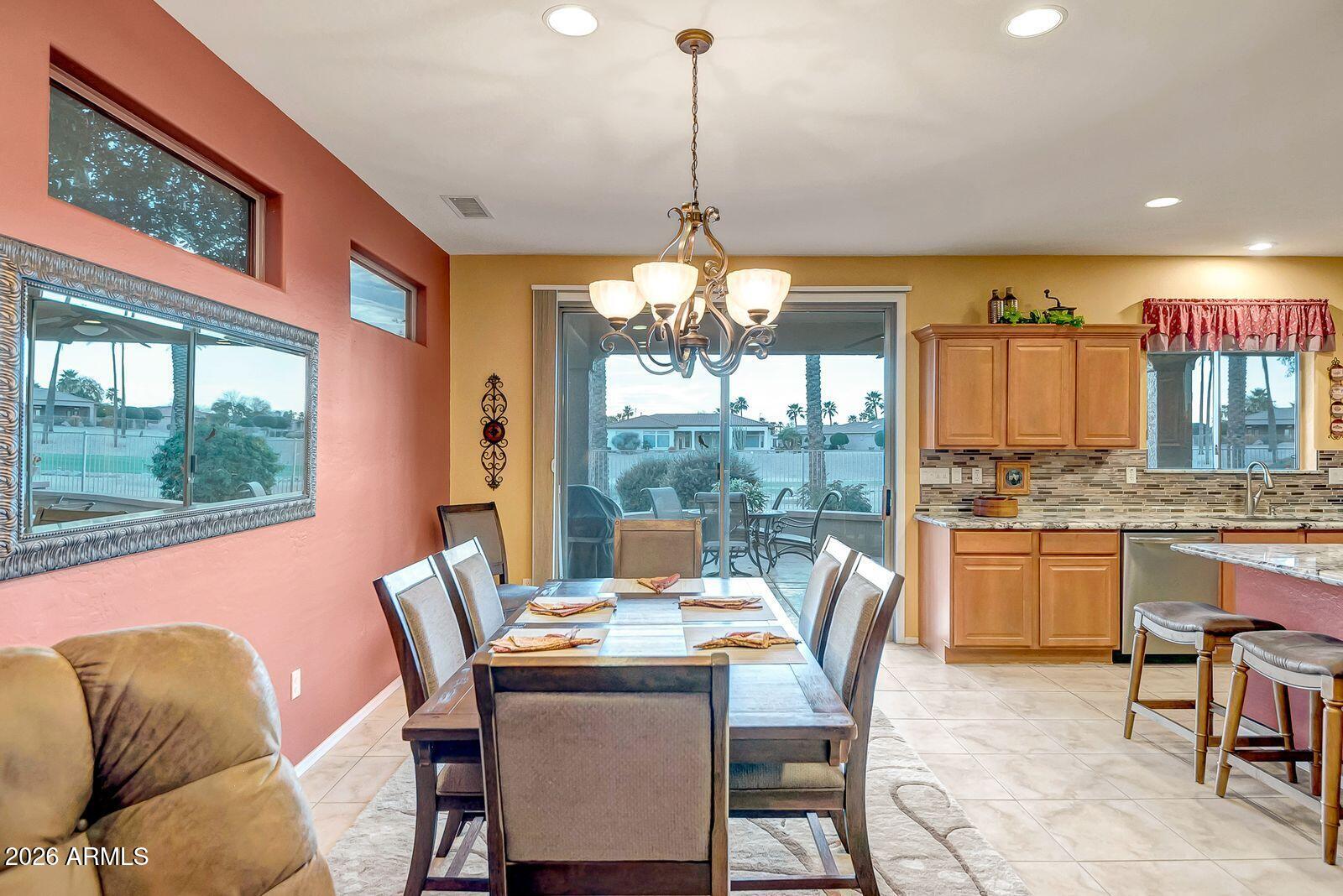 19848 North Rawhide Way Surprise, AZ 85387 - Photo 14 of 61 a dining room with furniture a chandelier and window
