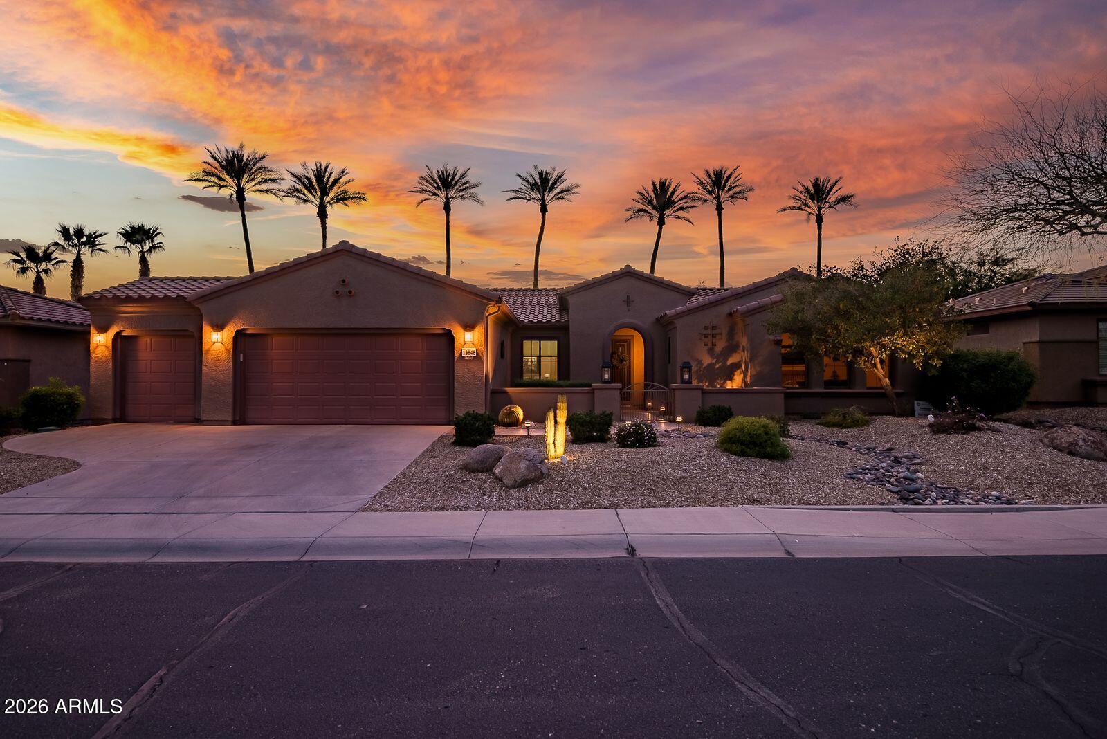 19848 North Rawhide Way Surprise, AZ 85387 - Photo 2 of 61 a front view of a house with a yard and garage