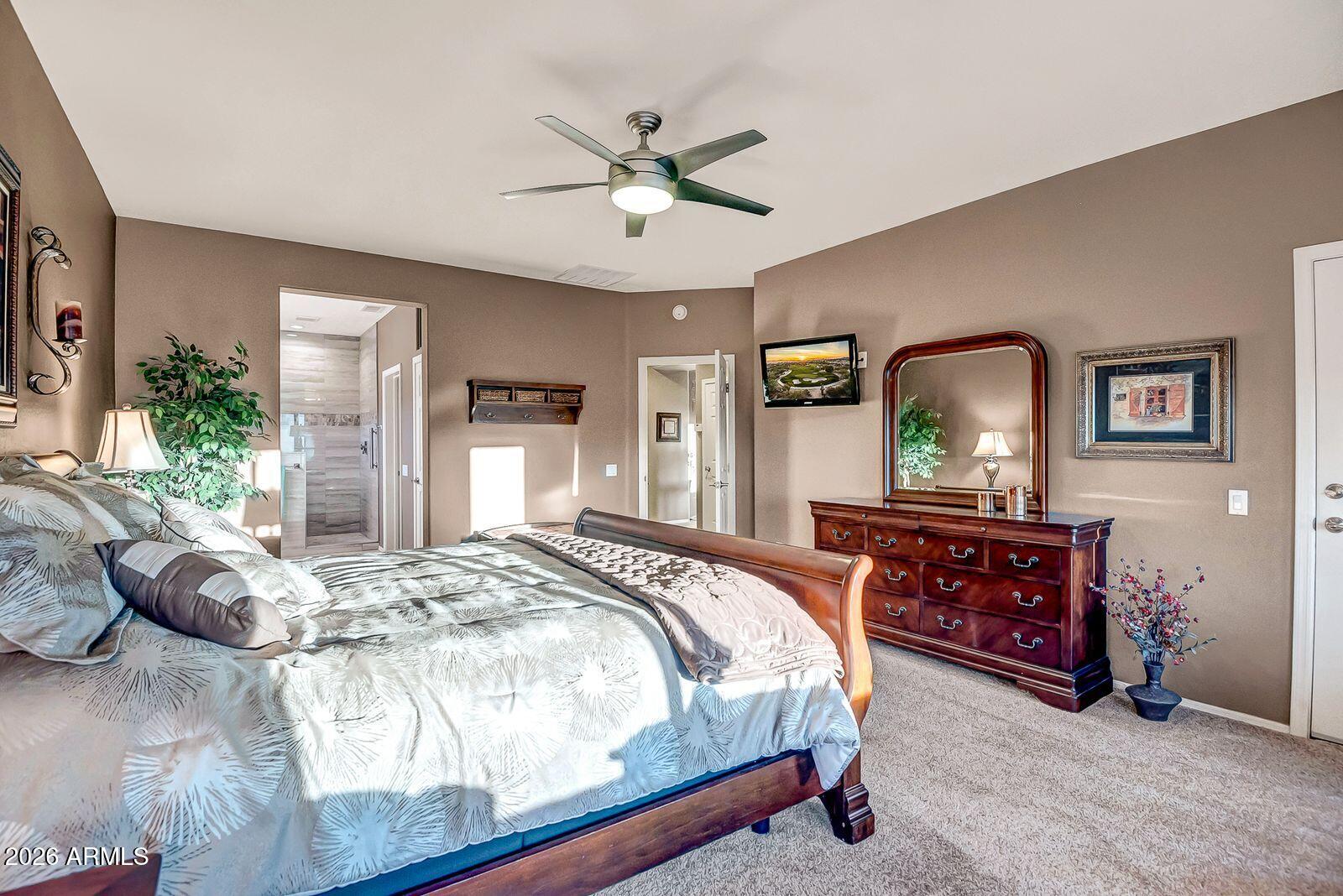 19848 North Rawhide Way Surprise, AZ 85387 - Photo 21 of 61 a bedroom with a bed and a chandelier