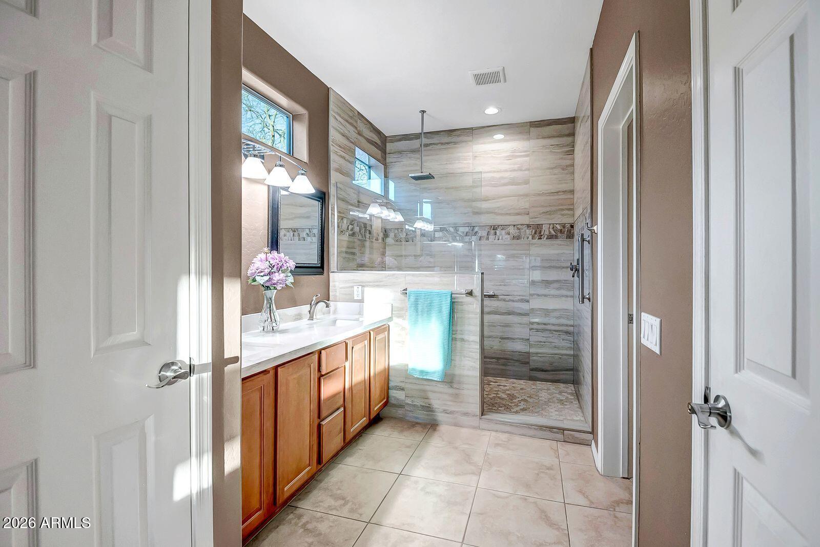 19848 North Rawhide Way Surprise, AZ 85387 - Photo 25 of 61 a bathroom with a mirror and a shower