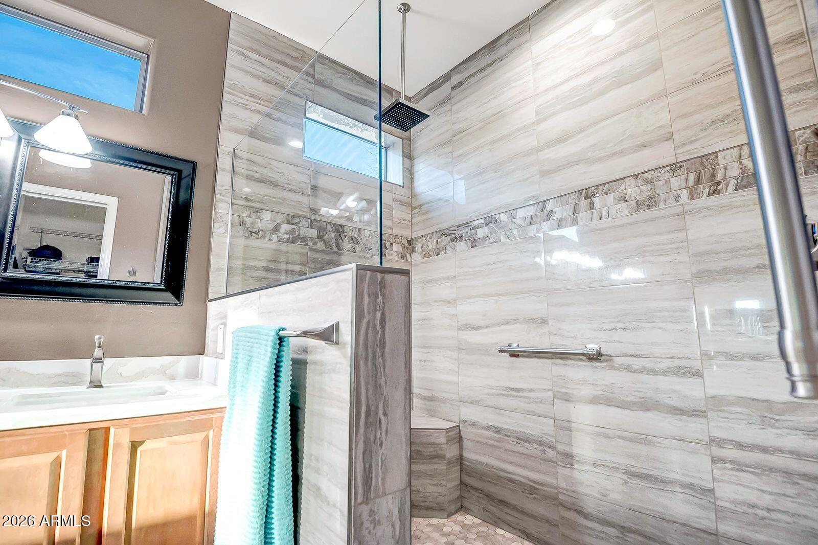 19848 North Rawhide Way Surprise, AZ 85387 - Photo 26 of 61 a bathroom with a granite countertop sink a mirror and shower