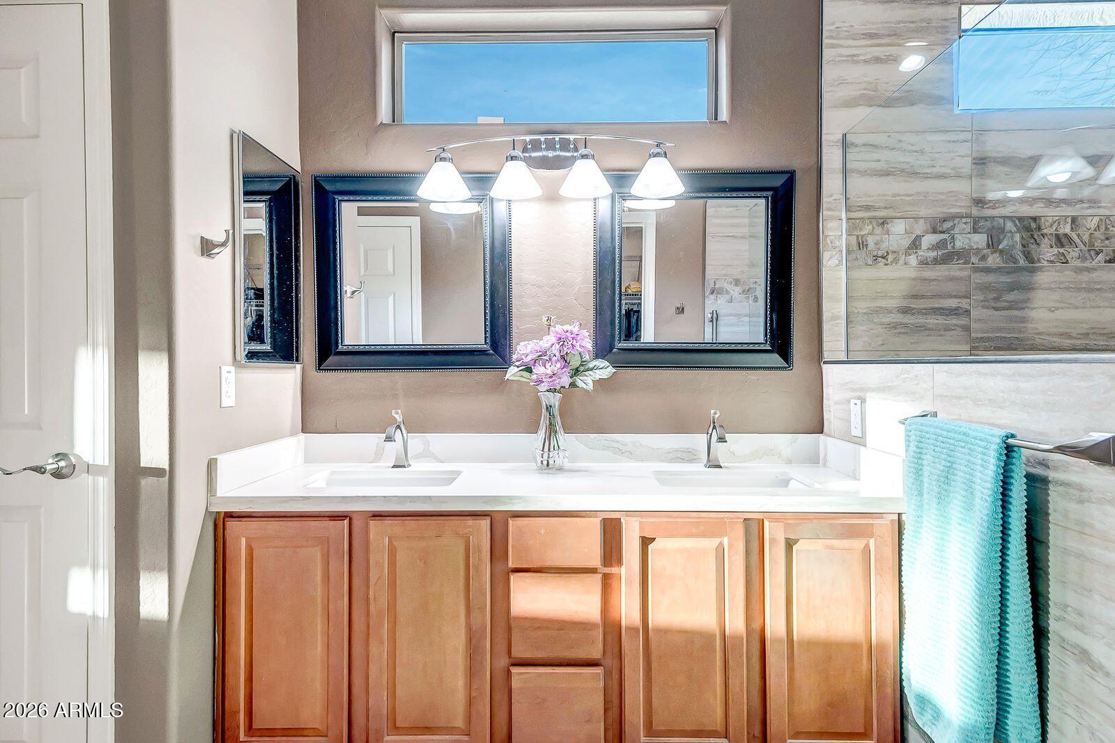 19848 North Rawhide Way Surprise, AZ 85387 - Photo 27 of 61 a bathroom with a double vanity sink and a mirror