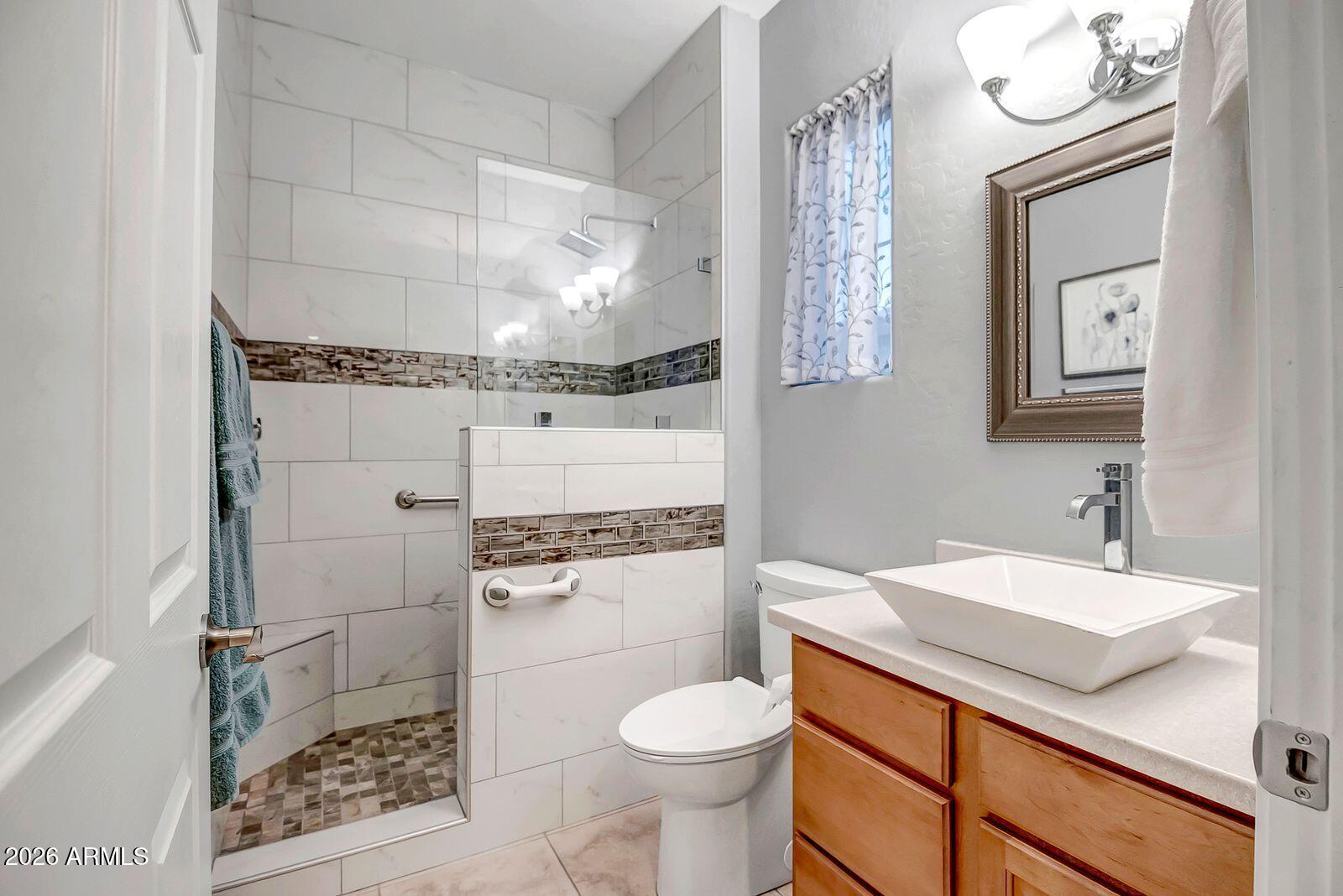 19848 North Rawhide Way Surprise, AZ 85387 - Photo 30 of 61 a bathroom with a granite countertop toilet sink and mirror