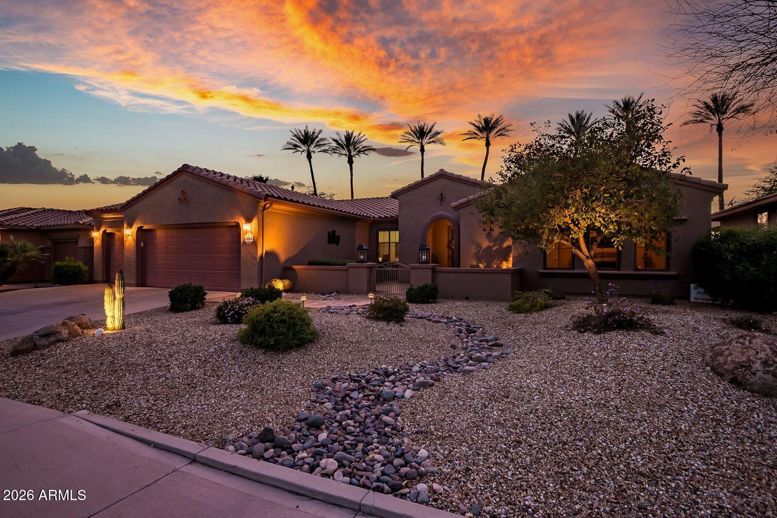 19848 North Rawhide Way Surprise, AZ 85387 - Photo 3 of 61 a front view of a house with a yard and garage