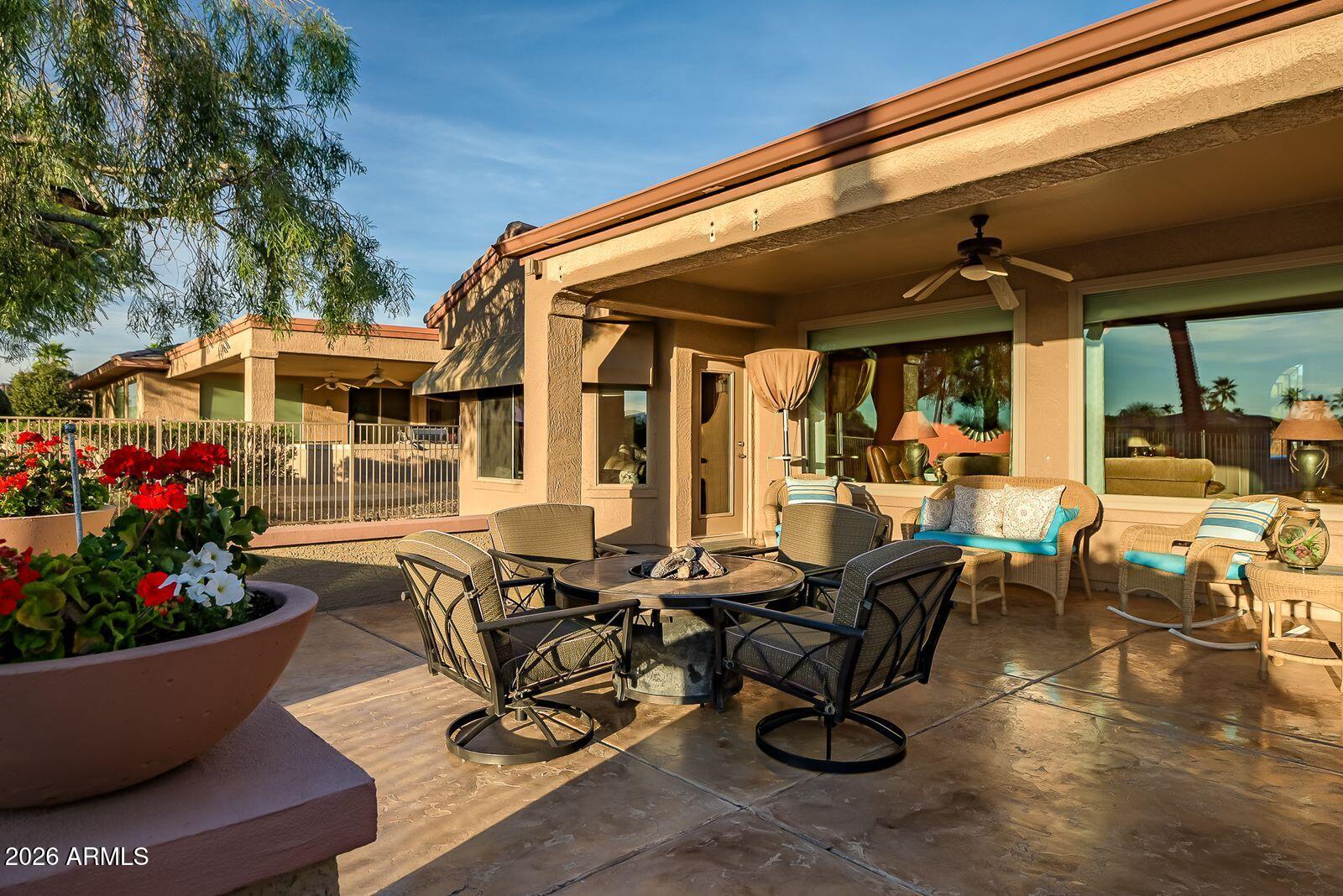 19848 North Rawhide Way Surprise, AZ 85387 - Photo 53 of 61 a view of a patio with table and chairs potted plants and floor to ceiling window