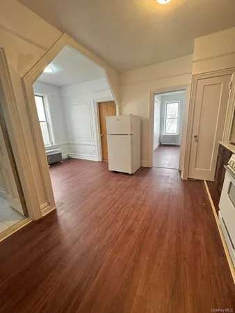 a view of a livingroom with wooden floor and stairs