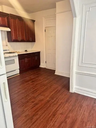 a view of kitchen with wooden floor and electronic appliances