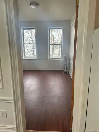 an empty room with windows and closet