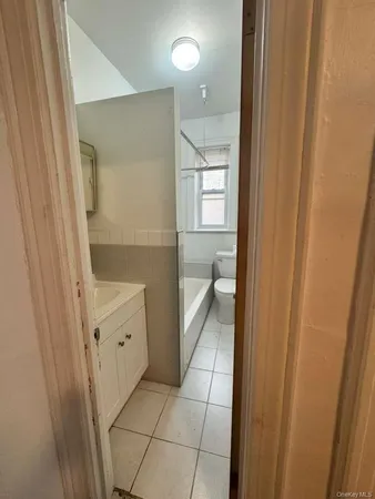 a bathroom with a granite countertop sink a mirror and a shower