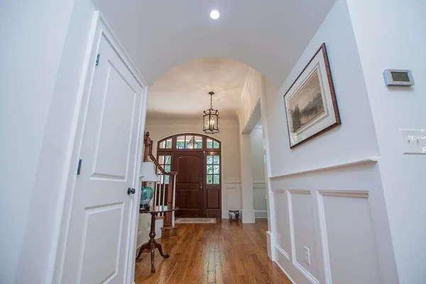a view of entryway and hall with wooden floor
