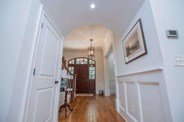 a view of entryway and hall with wooden floor