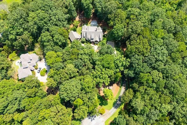 an aerial view of a house with yard swimming pool and outdoor seating