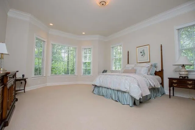 a spacious bedroom with a bed and a cabinets