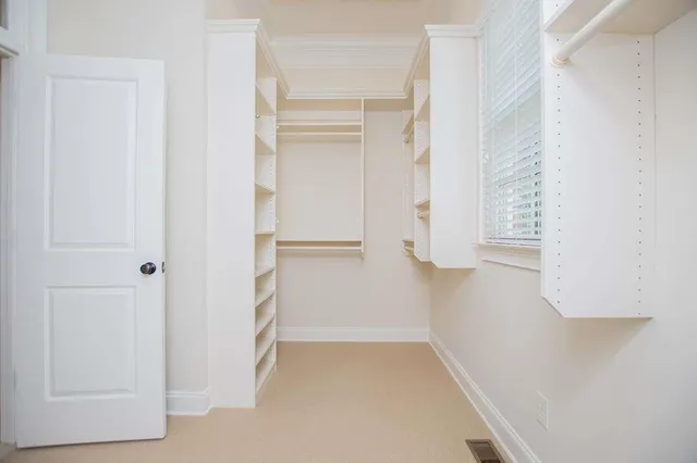 a view of an empty room with closet area