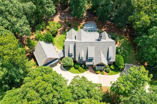 aerial view of a house with a yard patio and a garden