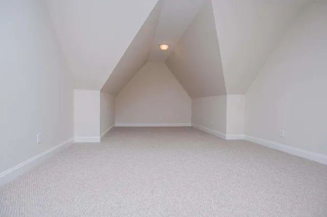 a spacious bedroom with a bed and a window