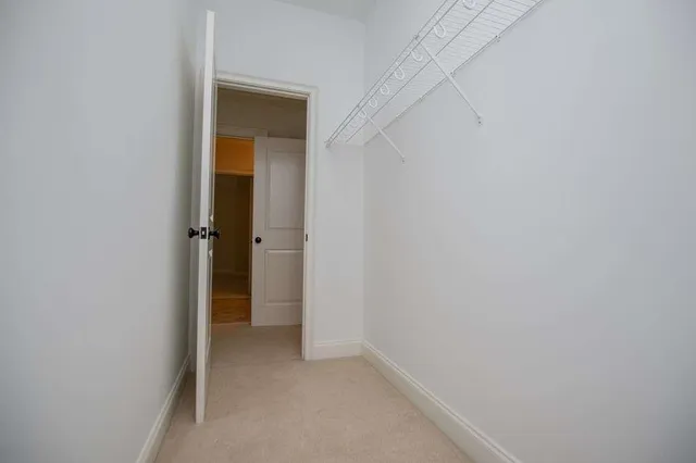 a bedroom with a bed and a walk in closet