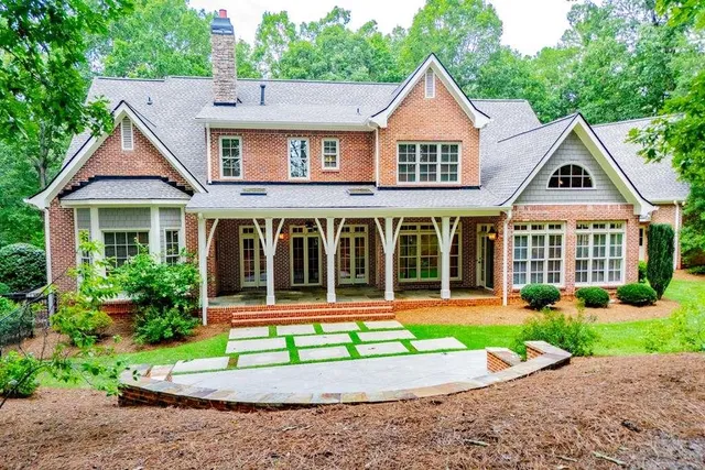 a aerial view of a house with yard and green space