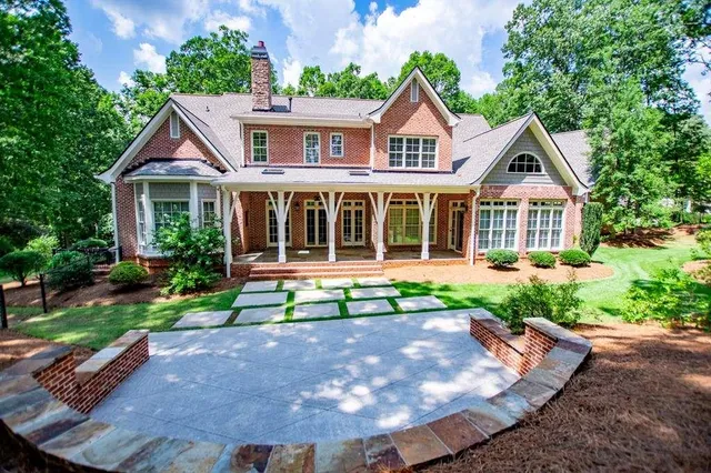 a backyard of a house with outdoor seating