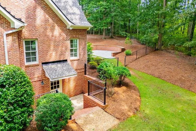 a view of backyard with large trees