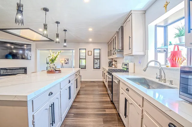 a bathroom with a sink a vanity and a large mirror
