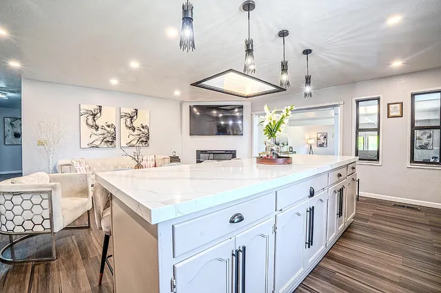 a living room with furniture and a potted plant