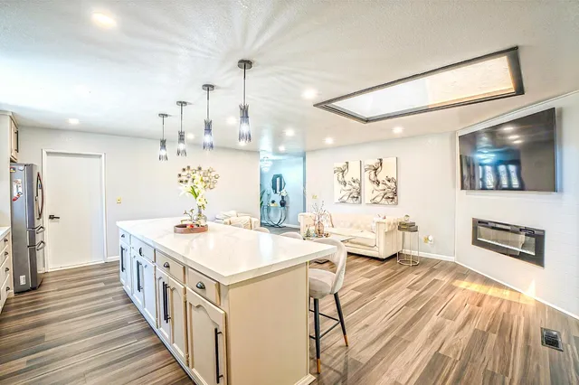 a kitchen with stainless steel appliances granite countertop a sink and a stove