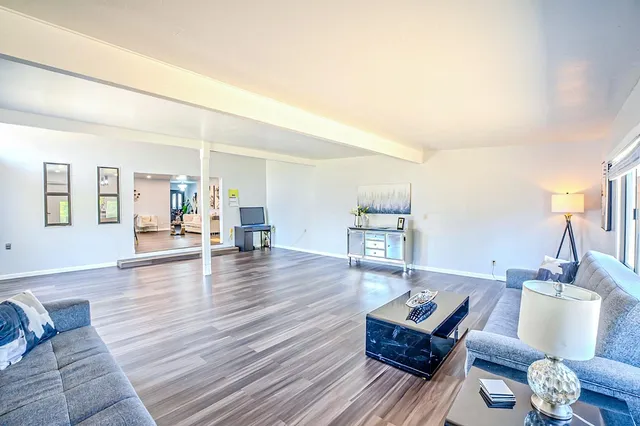 a view of dining room with furniture a rug and wooden floor