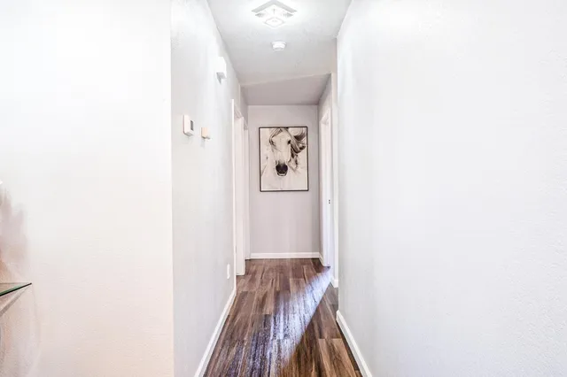 a bedroom with a bed a dresser and a chandelier