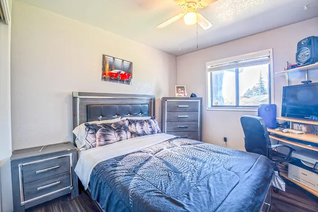 a bedroom with a bed and a chandelier