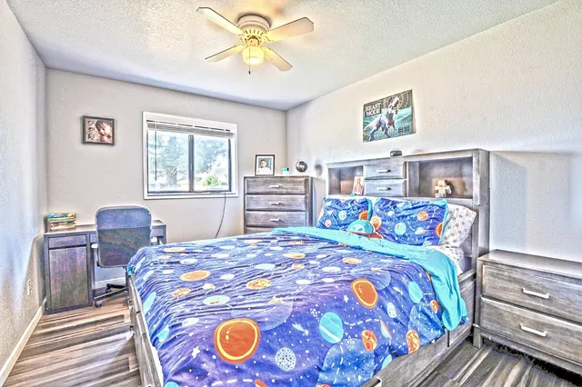 a bedroom with a bed and a chandelier