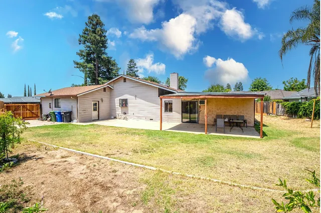 a view of a house with pool and a yard