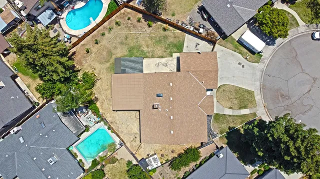 a view of a white house with a yard