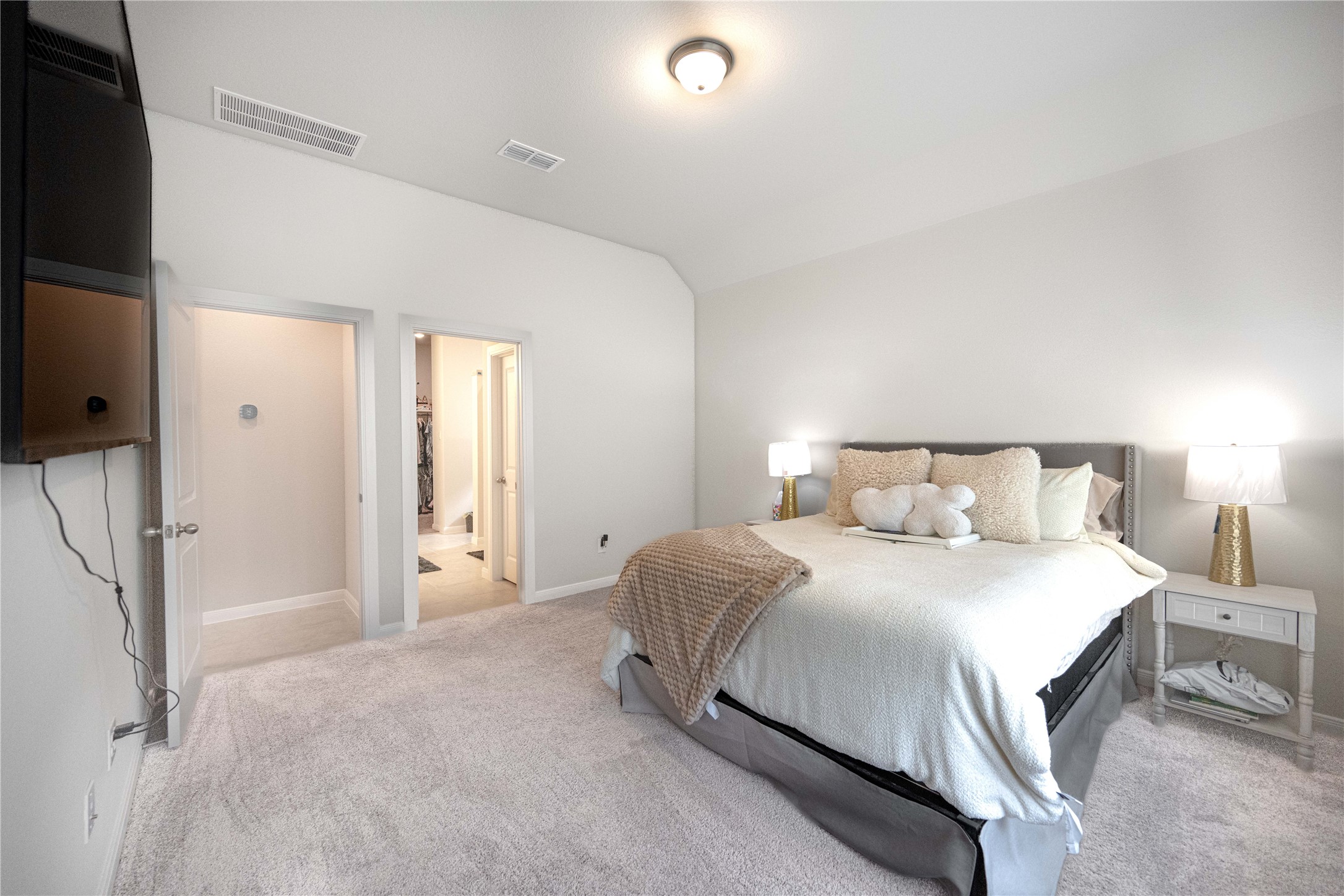 9026 Red Wolf Place Manvel, TX 77578 - Photo 10 of 17 a bedroom with a bed and a flat tv screen on dresser