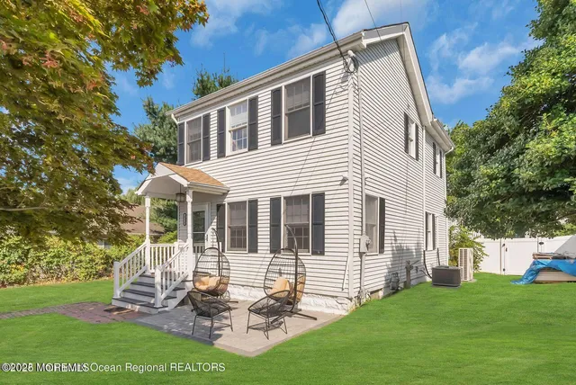 a front view of house with a garden and patio