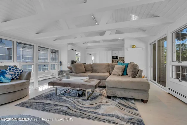 a living room with furniture and a book shelf
