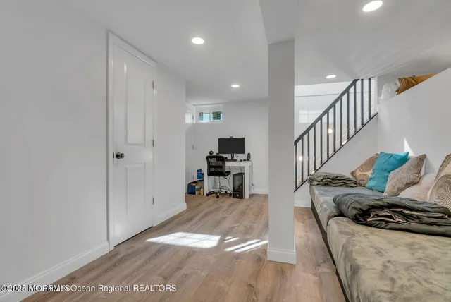 a view of a living room with furniture and a flat screen tv