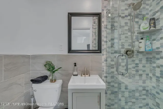 a bathroom with a sink a toilet and mirror