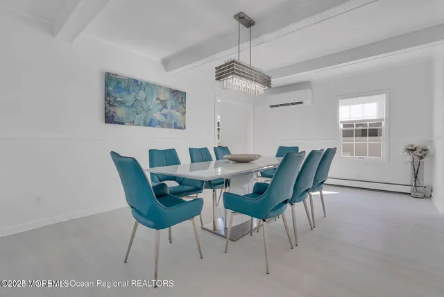 a view of a dining room with a table and chairs