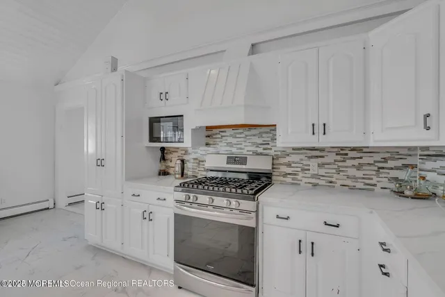 a kitchen with cabinets appliances and a sink