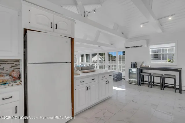 a kitchen with refrigerator and cabinets