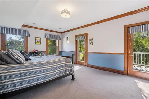 a bathroom with a toilet sink vanity and mirror