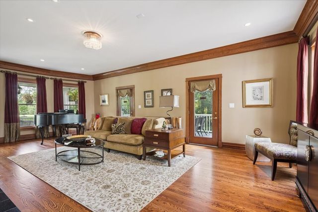 a view of a dining room with furniture a chandelier and wooden floor