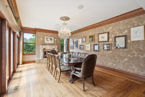 a view of a deck with a table and chairs with wooden floor and fence