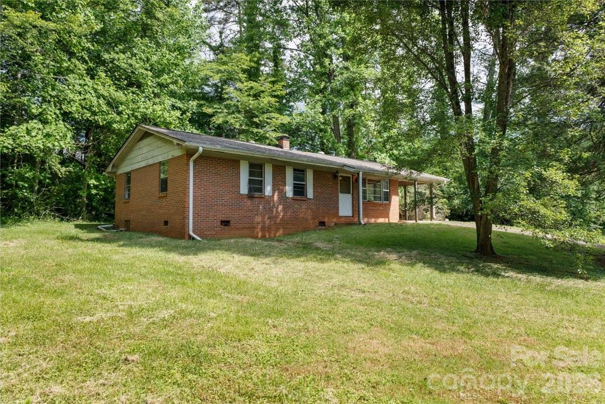 156 Old Sweetwater Road Robbinsville, NC 28771 - Photo 1 of 25 a view of a house with backyard and garden