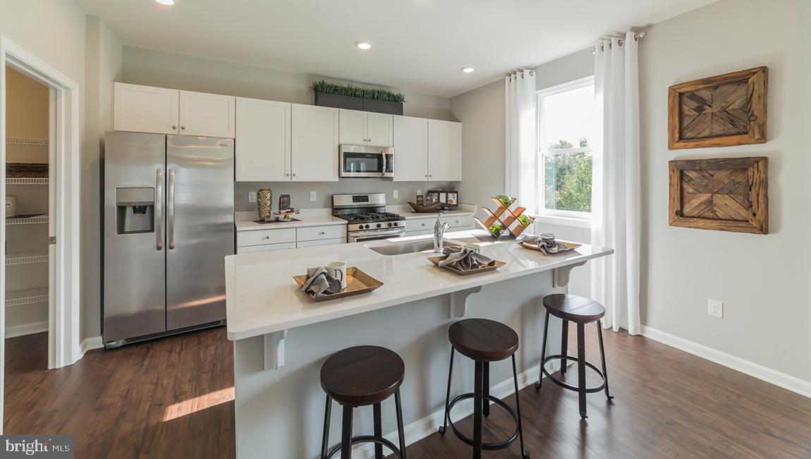 10 Moro Road Egg Harbor Township, NJ 08234 - Photo 11 of 42 a kitchen with stainless steel appliances a dining table and chairs