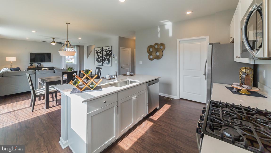 10 Moro Road Egg Harbor Township, NJ 08234 - Photo 12 of 42 a kitchen with a sink stove and wooden floor