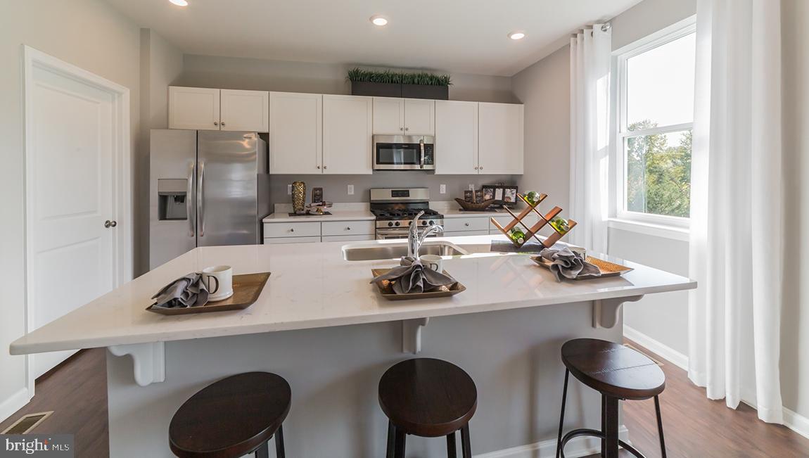 10 Moro Road Egg Harbor Township, NJ 08234 - Photo 4 of 42 a kitchen with a dining table chairs sink and cabinets