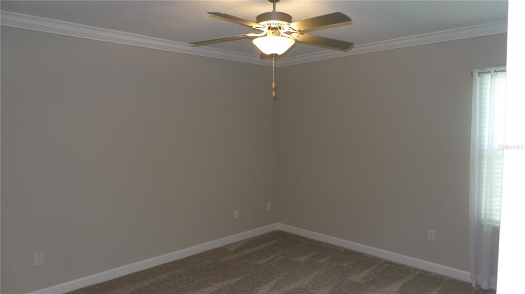 16715 Shell Bay Drive Land O Lakes, FL 34638 - Photo 11 of 19 an empty room with a window and a fan