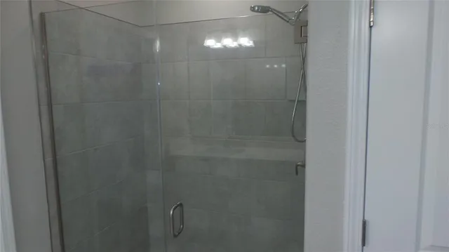 a bathroom with a glass shower door